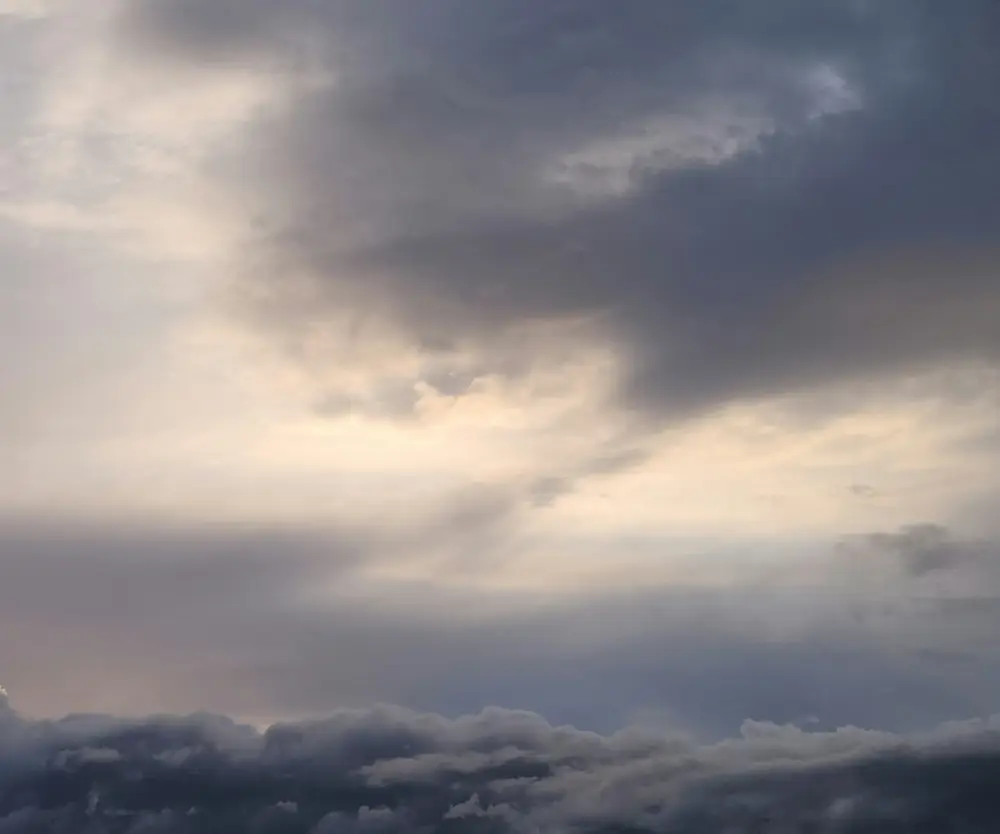 Dramatic clouds fill the sky at dusk.